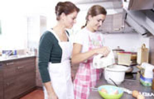 Hauswirtschafterin mit Auszubildender beim Backen