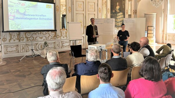 Ralf Bundschuh, Sachgebietsleiter 62 an der Regierung von Schwaben und Hannah Baumgardt, Heimatagentur begrüßen Teilnehmer des Netzwerktreffen