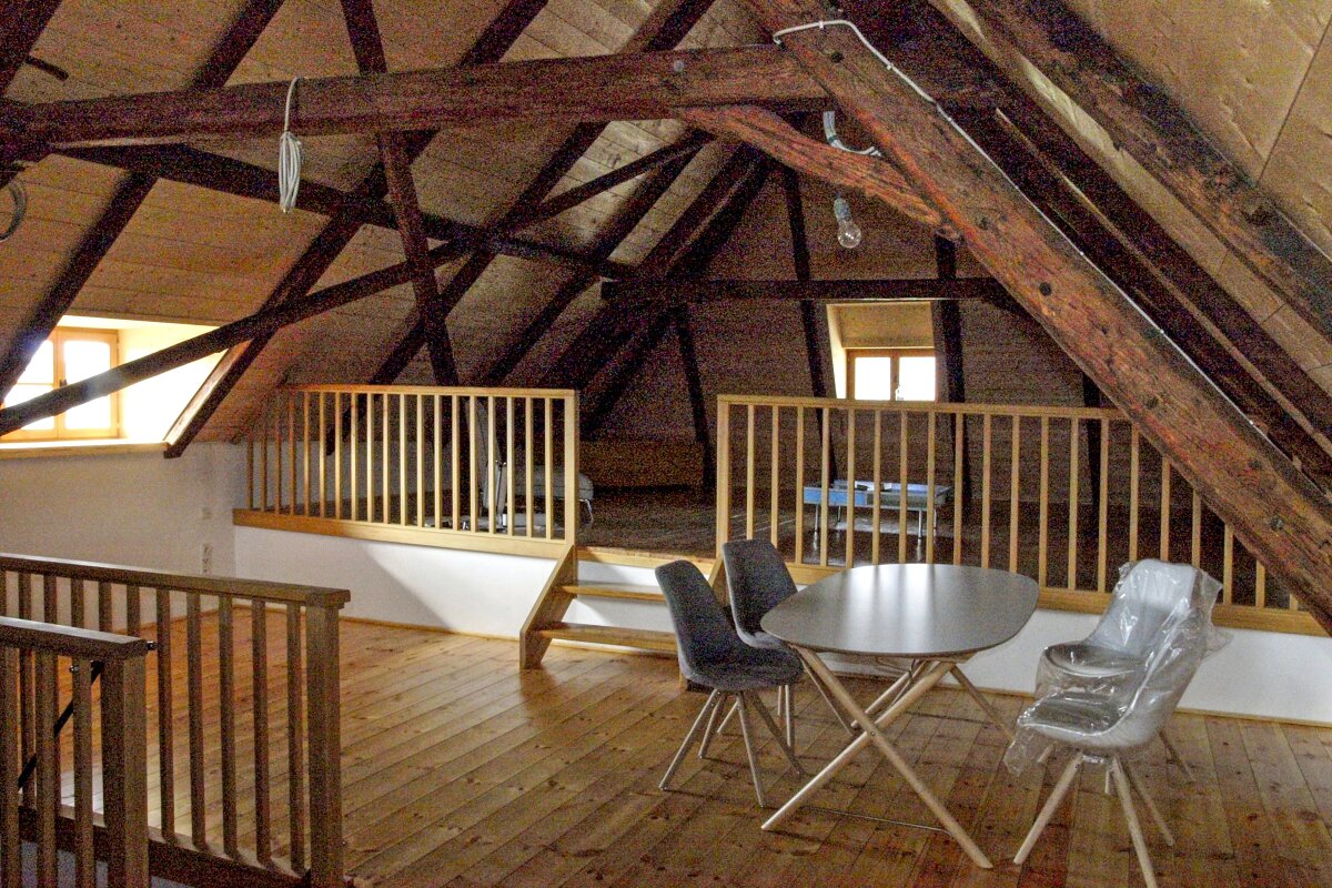 Innenansicht eines bis zum First offenen Dachgeschosses mit sichtbaren Holzsparren