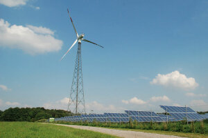 Windrad und Photovoltaikanlage mit Weg im Vordergrund