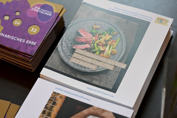 Titelblatt der Broschüre Premiumstrategie für Lebensmittel aus Bayern mit einem Teller mit Fleisch und Gemüse